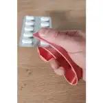 11) Pill Ejector - Helps open pill blister packs of almost any size of pill. The small container underneath will catch the pill before it drops.