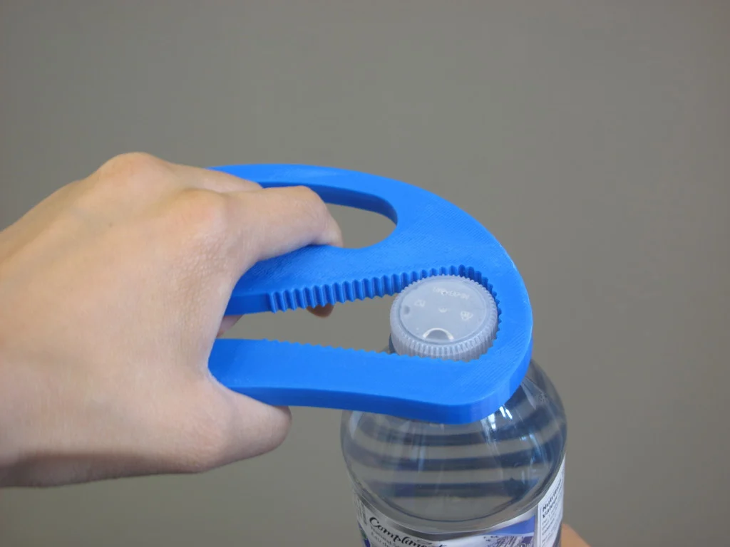 5) Bottle Opener - A handheld tool that helps people with arthritis, limited finger dexterity, or other disabilities open standard water bottle caps with just a small squeeze.