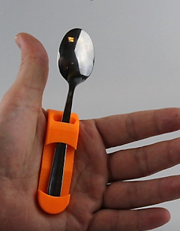 1) Fork and spoon support - An aid for using eating utensils. It is a single piece that fits the shape of the hand. Forks and spoons with flat bases slide into the two slots on the inside of the palm.